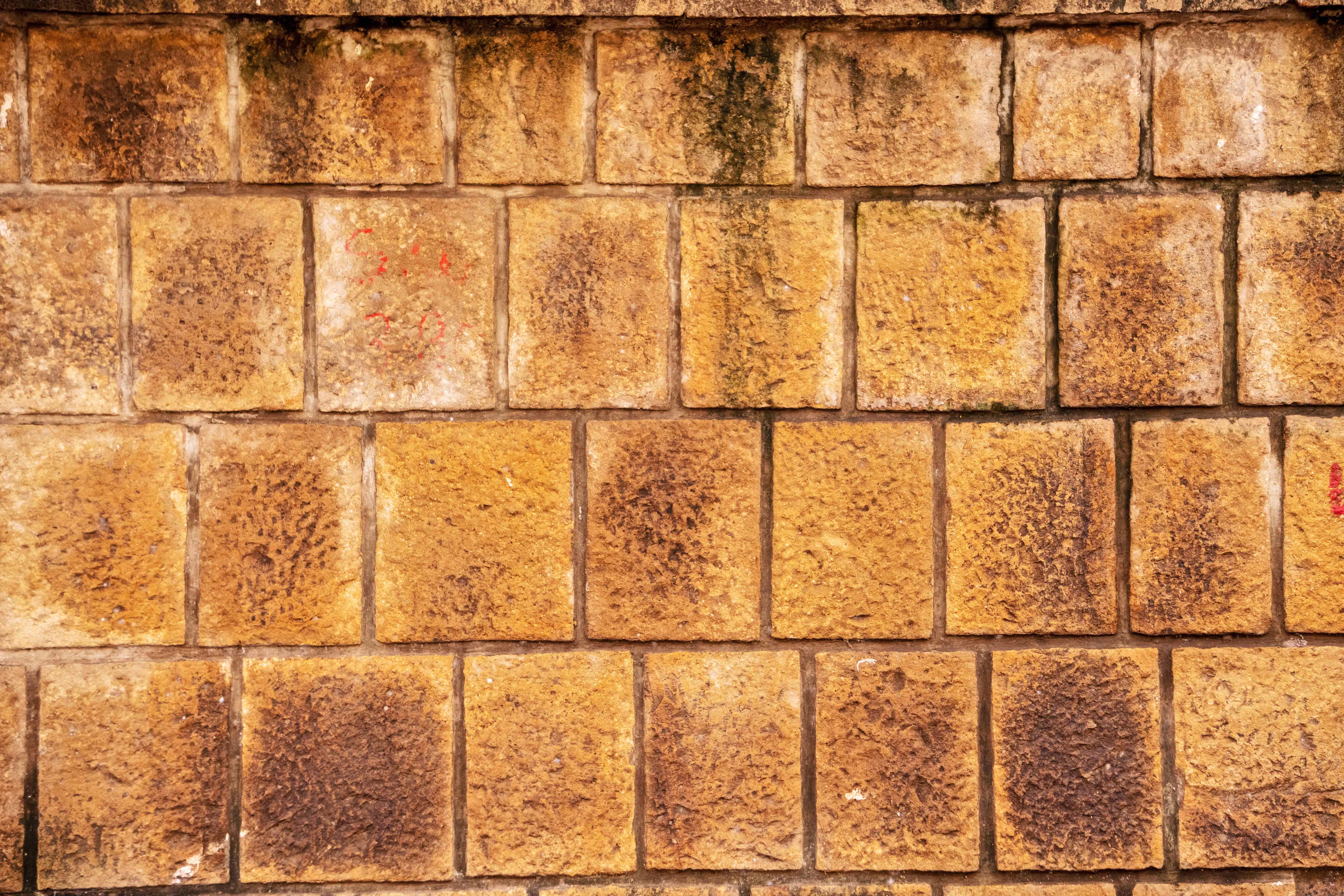 Weathered Natural Stone Masonry Wall Texture with Moss and Rustic Surface