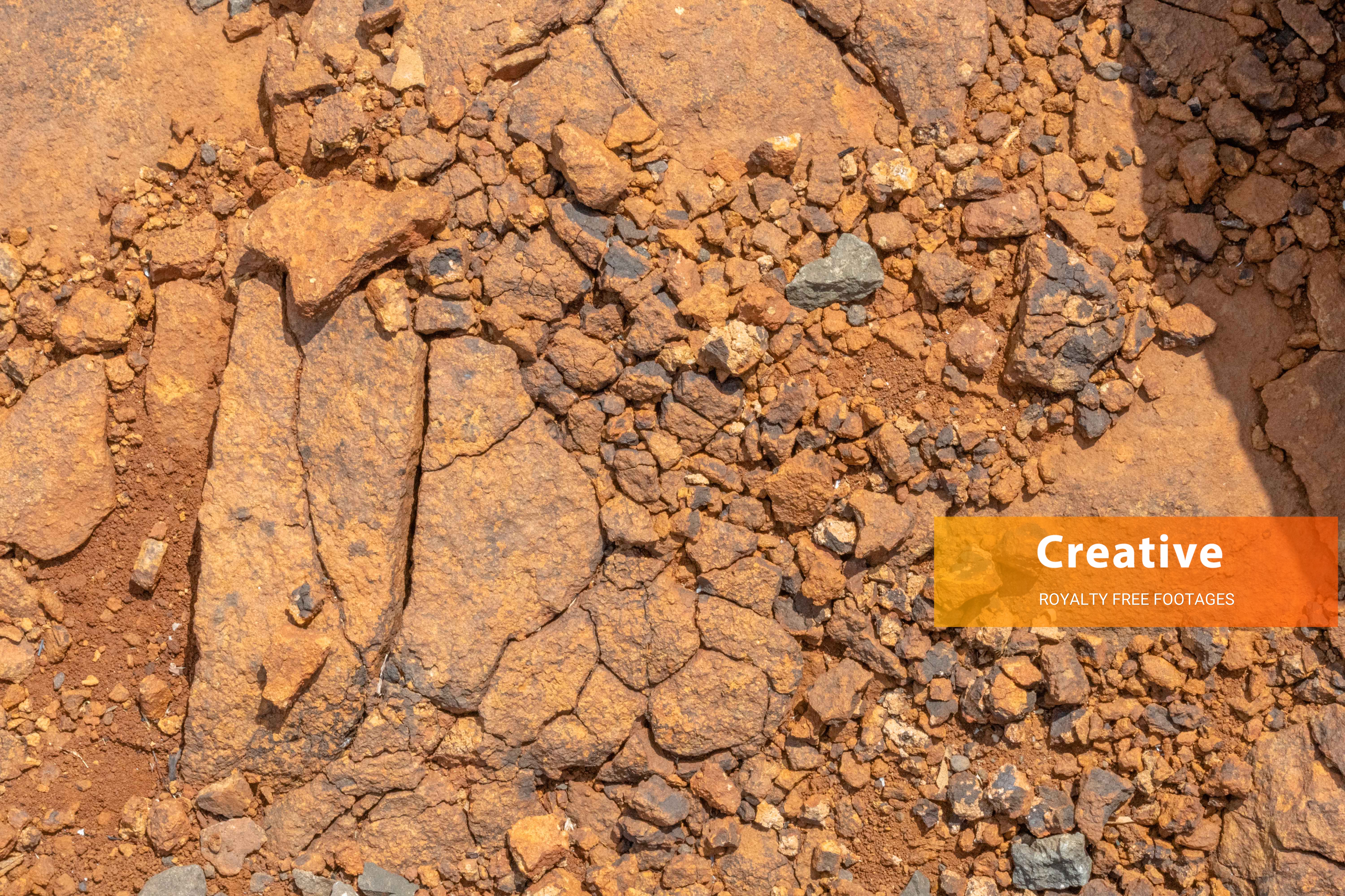Weathered Lateritic Rocky Ground with Fractured Bedrock and Iron-Rich Soil